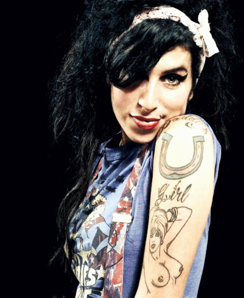 Popstar Amy Winehouse, displaying her 'Daddy's Girl' tattoo. 