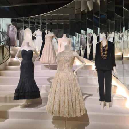 three of Chanel's designs (one white ball gown, black tuxedo suit and black taffeta strapless gown) photographed at the Chanel: Fashion Manifesto exhibition at the Victoria and Albert Museum, London.
